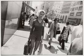 A photo of a woman walking down the streets of New York (Captured by Garry Windogrand)